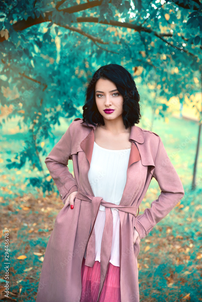 Young woman wearing dress and coat in nature Young woman wearing dress and coat in nature