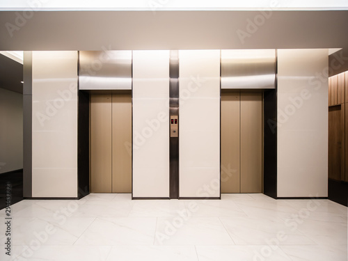 Modern steel elevator cabins in a business lobby or Hotel, Store, interior, office,perspective wide angle. Three elevators in hotel lobby