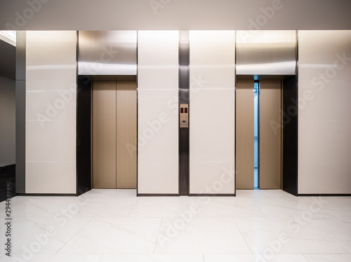 Modern steel elevator cabins in a business lobby or Hotel, Store, interior, office,perspective wide angle. Three elevators in hotel lobby