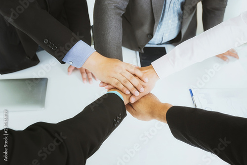 Concept of teamwork: Top view of hands business team showing unity with putting their hands together.