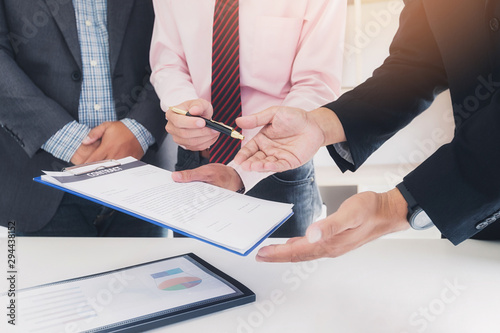 Canvas Print Businessman offering contract paper to his business partner for sign contract