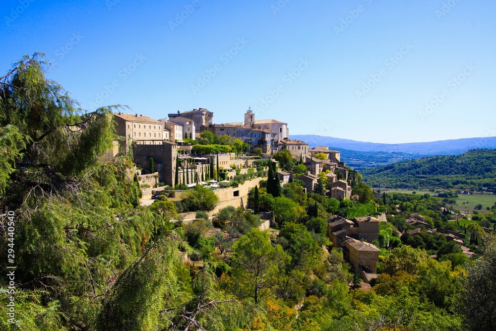 Panoramic view on medieval old french village on hill top against blue sky - Gordes, Provence, France