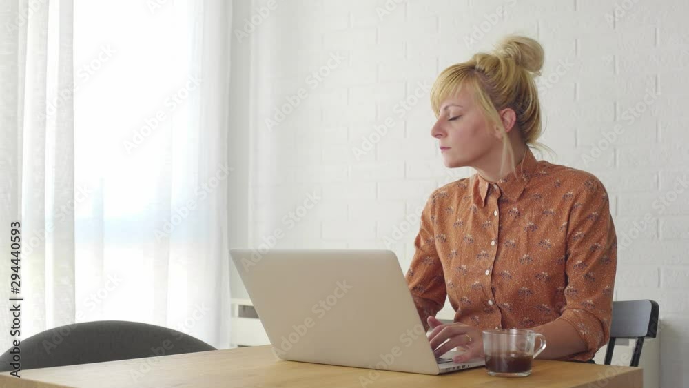 Young blonde business woman is very frustrated and nervous while working on laptop. Young blonde business woman is very frustrated and nervous while working on laptop.
