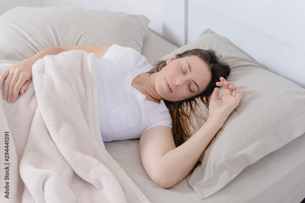 Beautiful woman sleeping in her bed. - obrazy, fototapety, plakaty 