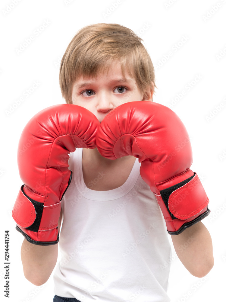 Sporty strong child boxing in red gloves and white t-shirt Sporty strong child boxing in red gloves and white t-shirt