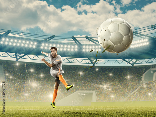Soccer player kicks a ball. Soccer championship. Stadium with fans © TandemBranding