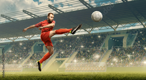 Soccer player kicks a ball. Soccer championship. Stadium with fans © TandemBranding
