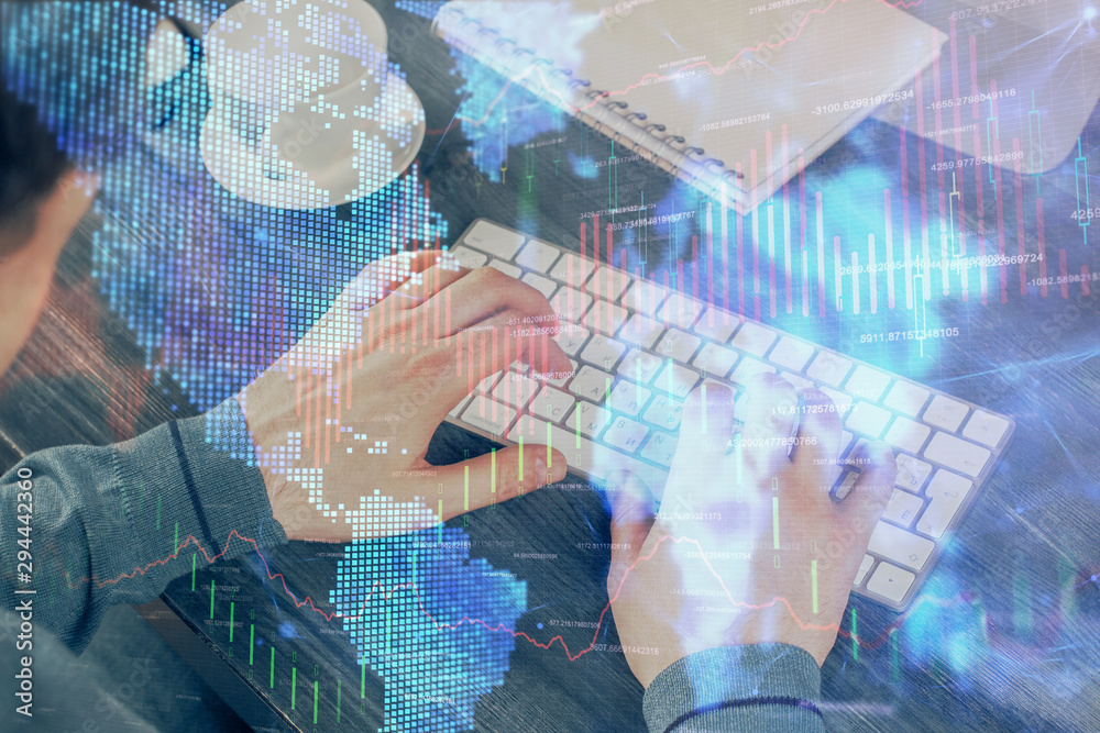 Double exposure of graph with man typing on computer in office on background. Concept of hard work. Double exposure of graph with man typing on computer in office on background. Concept of hard work.