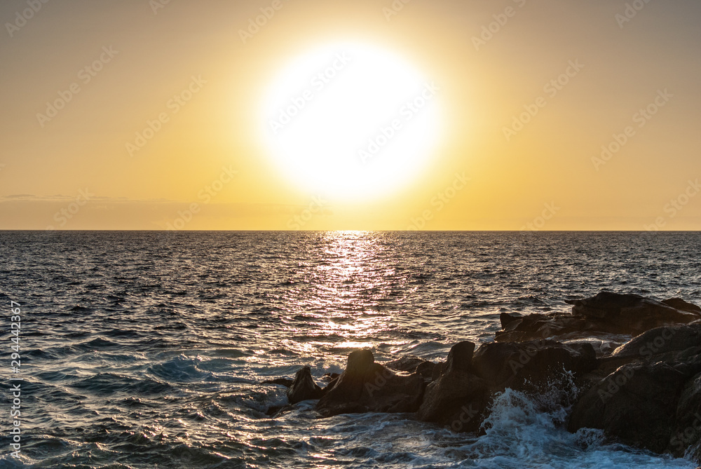 the sun sets over the horizon of the ocean the sun sets over the horizon of the ocean