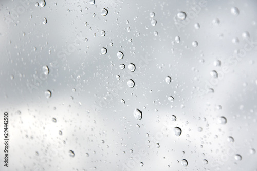 Rain drops with selective focus on transparent glass. Glass surface with water drops. Window with raindrops. water drops on glass. Rainy autumn weather