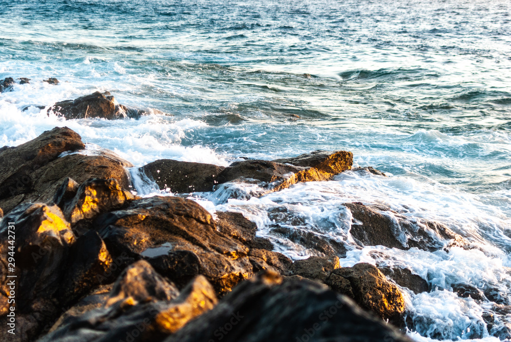 waves cover a stone coast waves cover a stone coast
