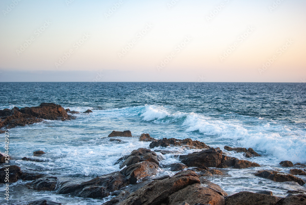 foamy waves of the atlantic ocean beat against stones