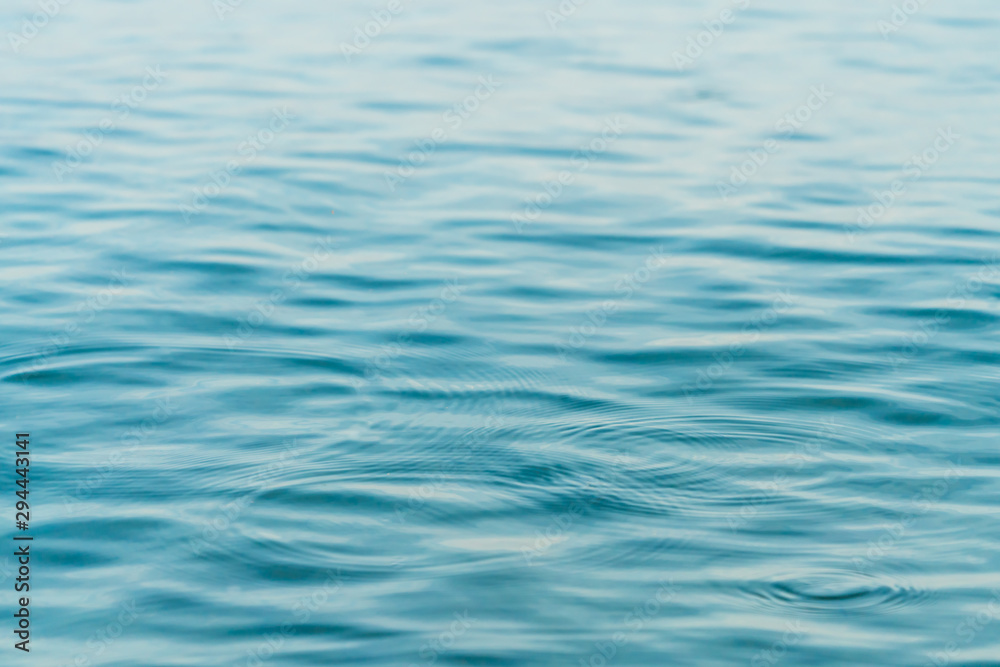 Ripples on surface of blue water background