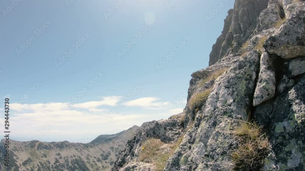 Hiker POV climbing on the rocky risky mountain towards the top of Pirin in Bulgaria Hiker POV climbing on the rocky risky mountain towards the top of Pirin in Bulgaria