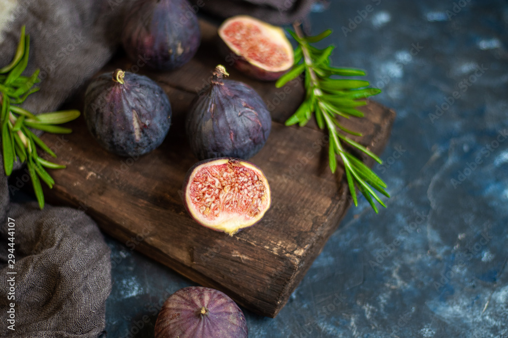 Ripe, beautiful, purple figs. Sweet and juicy. Mediterranean fruit is very healthy. You can jerk and cook jam. There is empty space on a dark copyspace background. Food for vegetarians. 