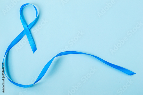  Light blue ribbon on blue background, prostate cancer awareness, men's health awareness Movember, blue November.