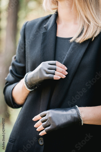 woman in a jacket and gloves with a chain, close-up