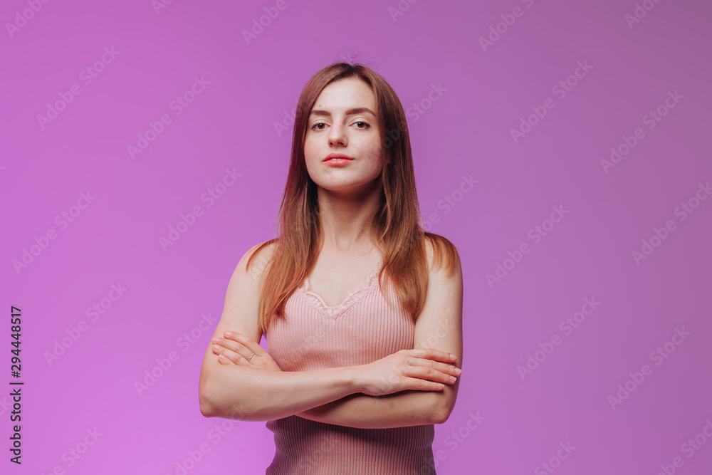 girl crossed her arms against the pink background girl crossed her arms against the pink background