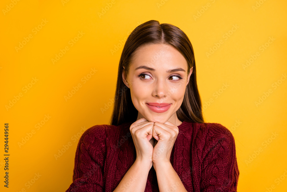 Close up photo of choosing girl making up her mind about something while isolated with yellow background Close up photo of choosing girl making up her mind about something while isolated with yellow background