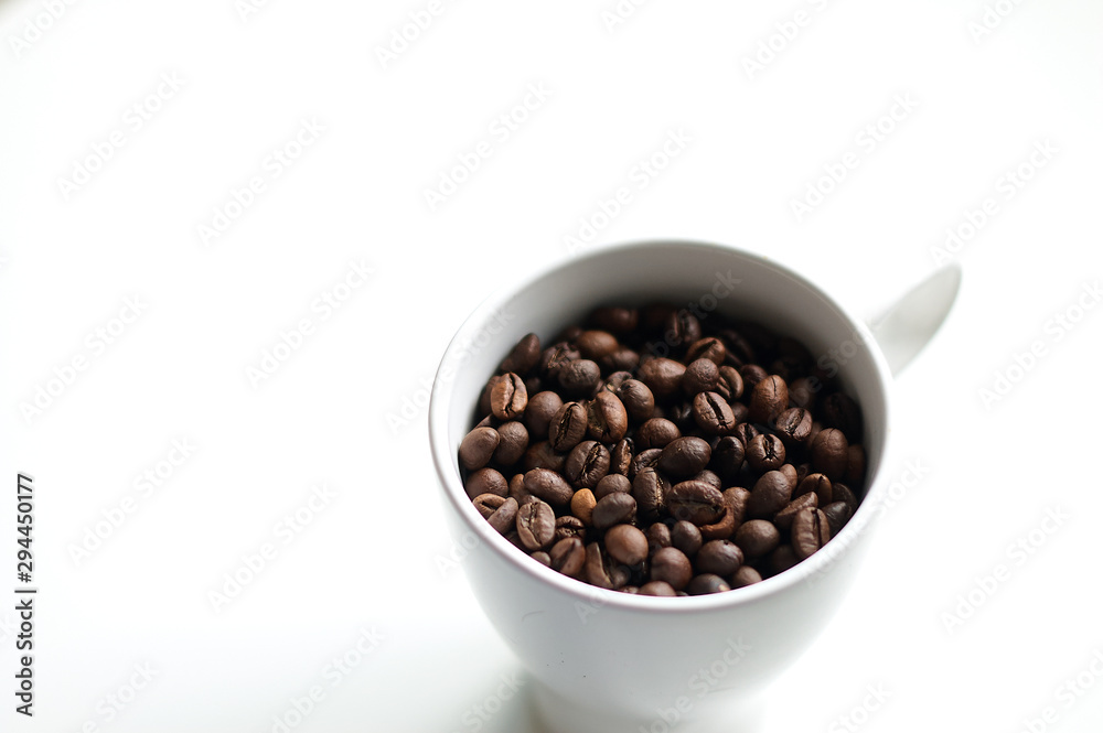Freshly roasted coffee beans in a white bowl. Freshly roasted coffee beans in a white bowl.