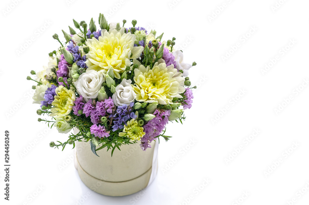 Bouquet of flowers in a round gift box on a white background. Great Gift for Wedding, Birthday, Valentine's Day or Mother's Day. Copy space