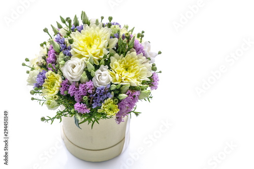 Bouquet of flowers in a round gift box on a white background. Great Gift for Wedding, Birthday, Valentine's Day or Mother's Day. Copy space