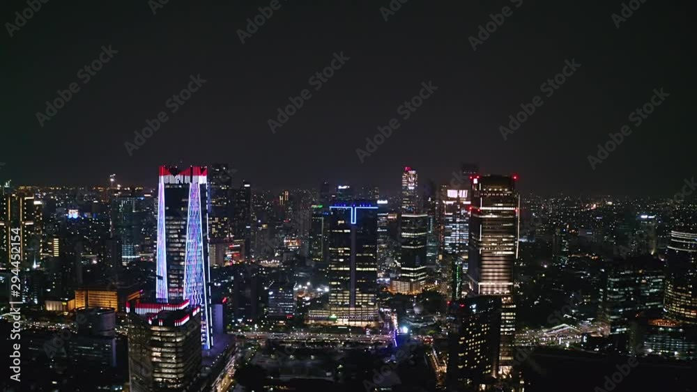 custom made wallpaper toronto digitalJAKARTA, Indonesia - October 03, 2019: Exotic aerial view of business district with night lights and modern skyscrapers. Shot in 4k resolution from a drone flying forwards
