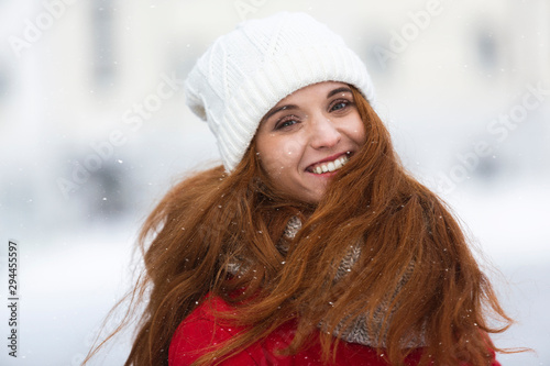 Portrait of beautiful smiling girl in winter clothes