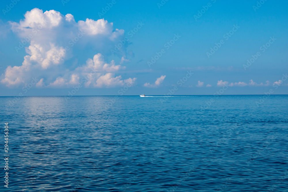 Calm Black Sea in the early morning with a boat on the horizon