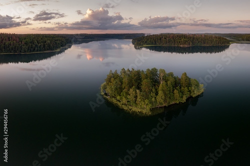 Aerial view of a calm lake with islands covered by forest