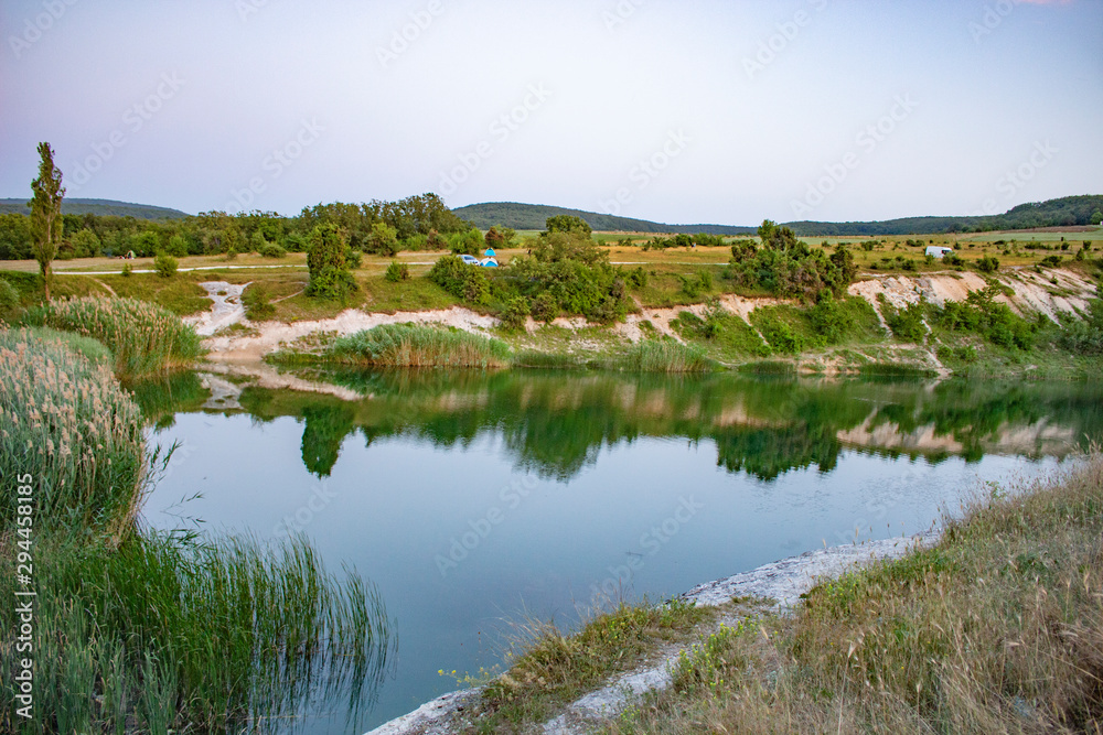 The lake in the mountains. Mountain landscape with a pond. Natural landscape in Crimea.