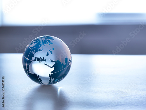 Global Markets, A glass globe illustrating the world on a desk. photo