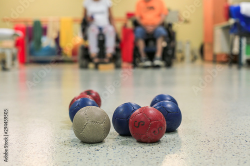 Disabled Boccia players training on a wheelchair. Close up of little balls photo