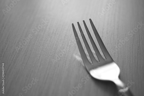 fork on the wooden table, black and white photo.