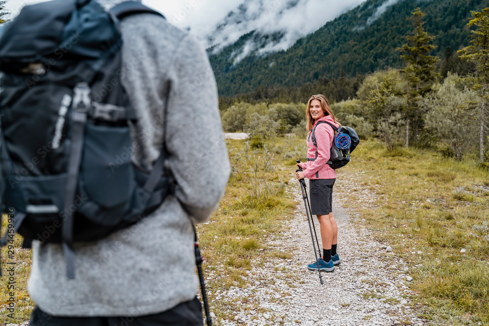 Young couple on a hiking trip, Vorderriss, Bavaria, Germany Young couple on a hiking trip, Vorderriss, Bavaria, Germany