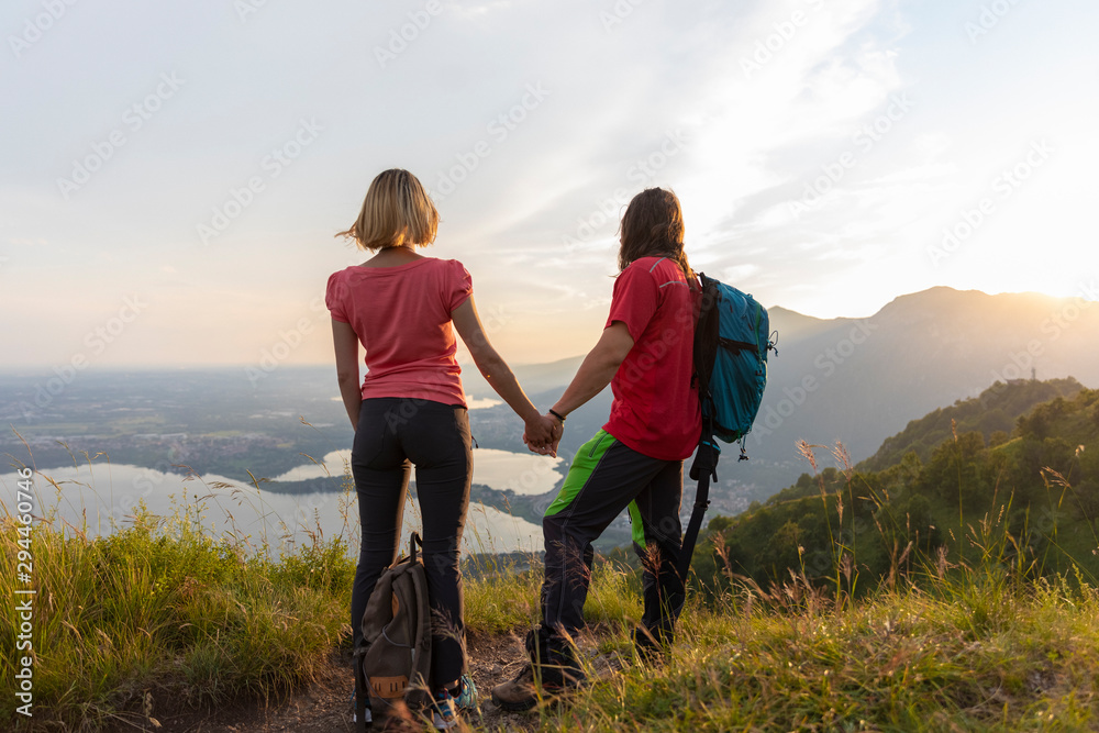 Young couple in the mountains, looking at view Young couple in the mountains, looking at view