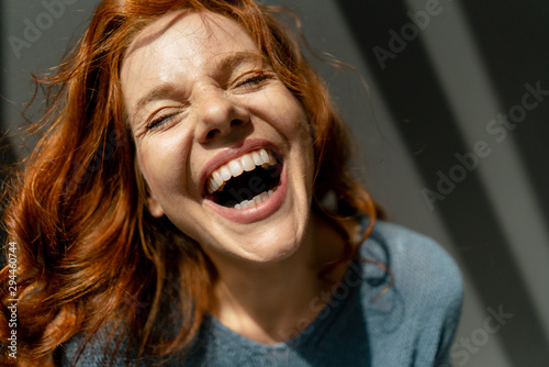 Portrait of laughing redheaded woman photo