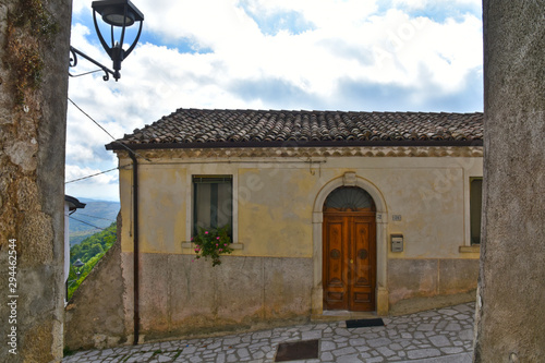 Province of Avellino, Italy, 09/28/2019. A narrow street among the old houses of a medieval village. The architectural style is typically Mediterranean.