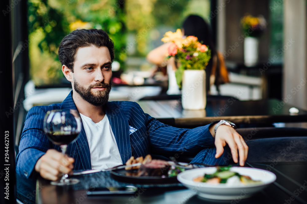 Successful intelligent business man relaxing in a luxury restaurant outdoors, confident thoughtful entrepreneur, wealthy men pensive rest and waiting someone in the modern coffee shop terrace. Successful intelligent business man relaxing in a luxury restaurant outdoors, confident thoughtful entrepreneur, wealthy men pensive rest and waiting someone in the modern coffee shop terrace.