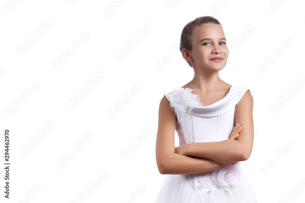Little beautiful European girl with a slight smile on her face in a white dress crossed her arms over her chest and looks at the camera isolated on white background. Copy space for text. Little beautiful European girl with a slight smile on her face in a white dress crossed her arms over her chest and looks at the camera isolated on white background. Copy space for text.