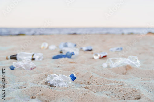 Fototapeta Naklejka Na Ścianę i Meble -  Environmental or polution concept. Empty plastic bottles on sea beach
