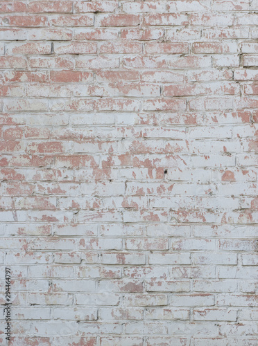  old white brick wall with light red scuffs and sprinkled paint vertical layout