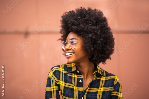 young african american woman with afro and glasses looking away photo
