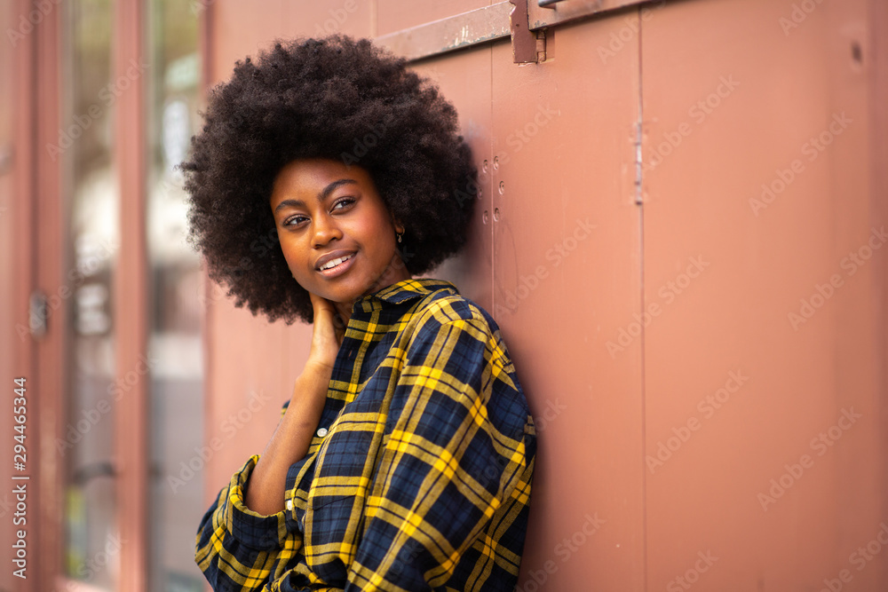 beautiful young black woman with afro hair glancing beautiful young black woman with afro hair glancing