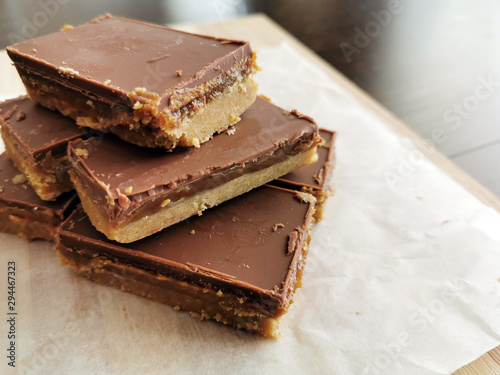 Millionaire's shortbread with chocolate and caramel. Copy space is on the right side. 