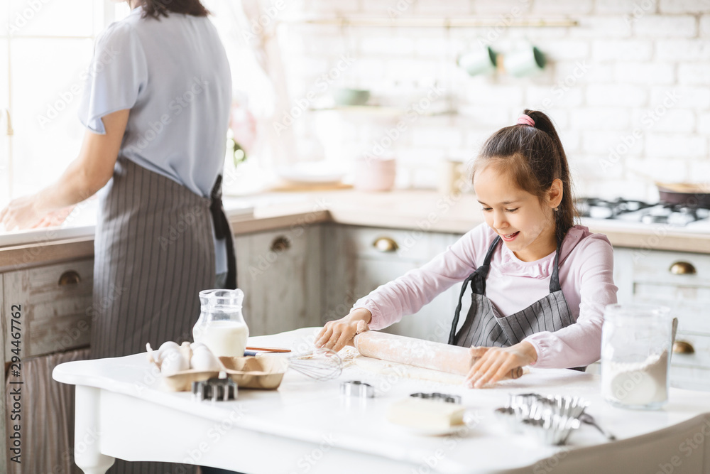 Little girl learning how to use rolling pin Little girl learning how to use rolling pin