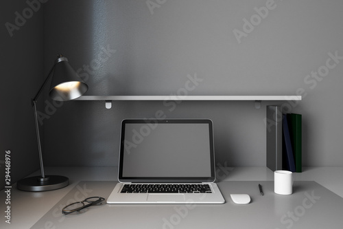 Modern designer workplace with empty laptop