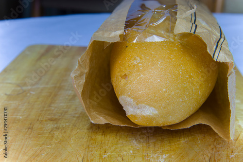 Fresh Baguette in a paper bag closeup copy space. photo