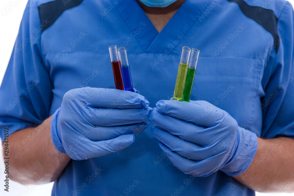 Chemist working with test tube. He's holding it and looking on it isolated on white Chemist working with test tube. He's holding it and looking on it isolated on white
