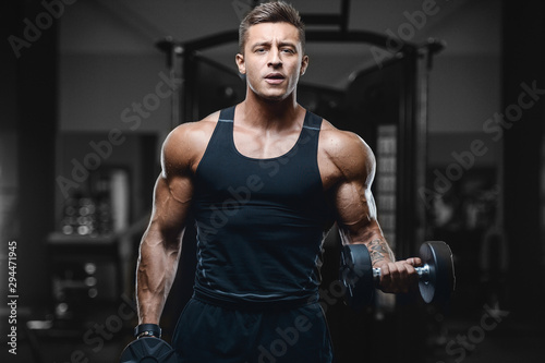 Handsome strong athletic men pumping up muscles workout fitness and bodybuilding concept background - muscular bodybuilder fitness men doing arms abs back exercises in gym naked torso.